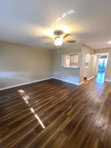 a view of wooden floor and windows in a room