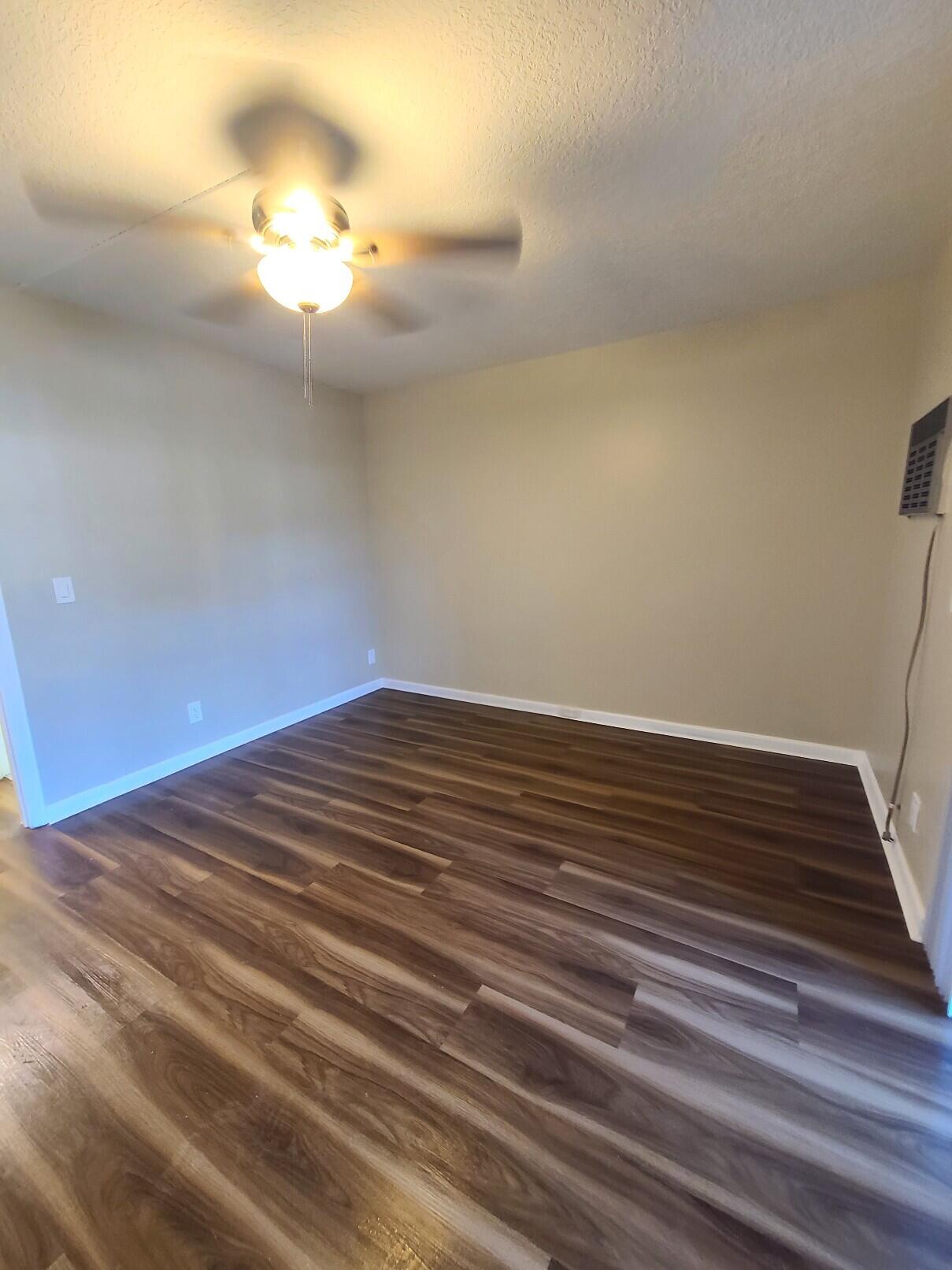 82 Canterbury D, Unit 82 West Palm Beach, FL 33417 - Photo 11 of 13 a view of empty room with wooden floor