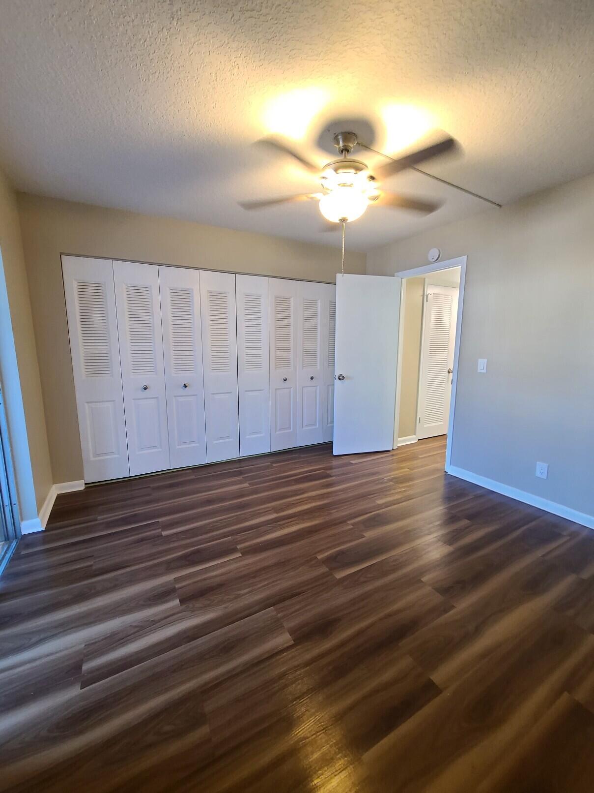 82 Canterbury D, Unit 82 West Palm Beach, FL 33417 - Photo 12 of 13 a view of a room with wooden floor