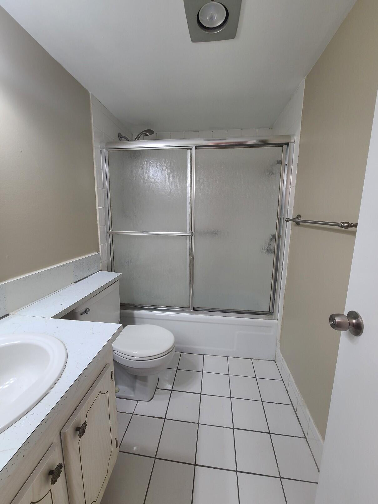 82 Canterbury D, Unit 82 West Palm Beach, FL 33417 - Photo 9 of 13 a bathroom with a sink a toilet and a shower