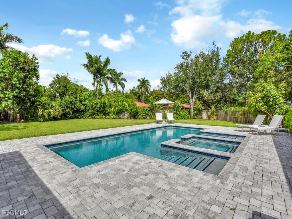 1803 Ardmore Road Fort Myers, FL 33901 - Photo 1 of 39 a view of backyard with swimming pool and green space