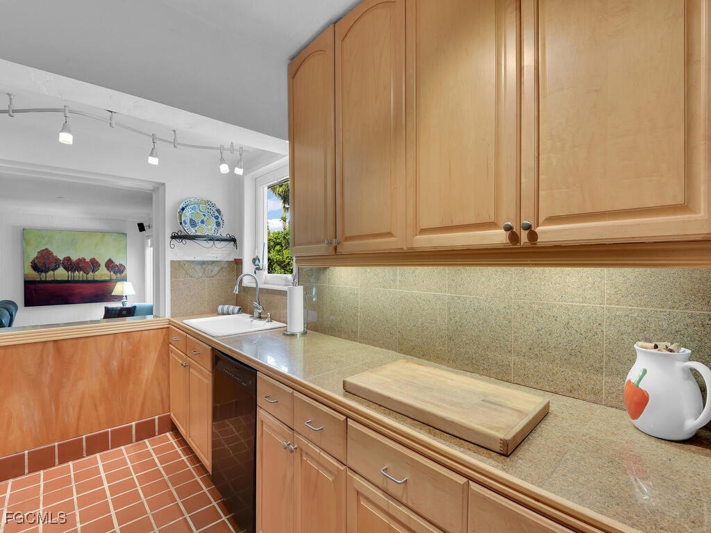 1803 Ardmore Road Fort Myers, FL 33901 - Photo 12 of 39 a kitchen with a sink and cabinets