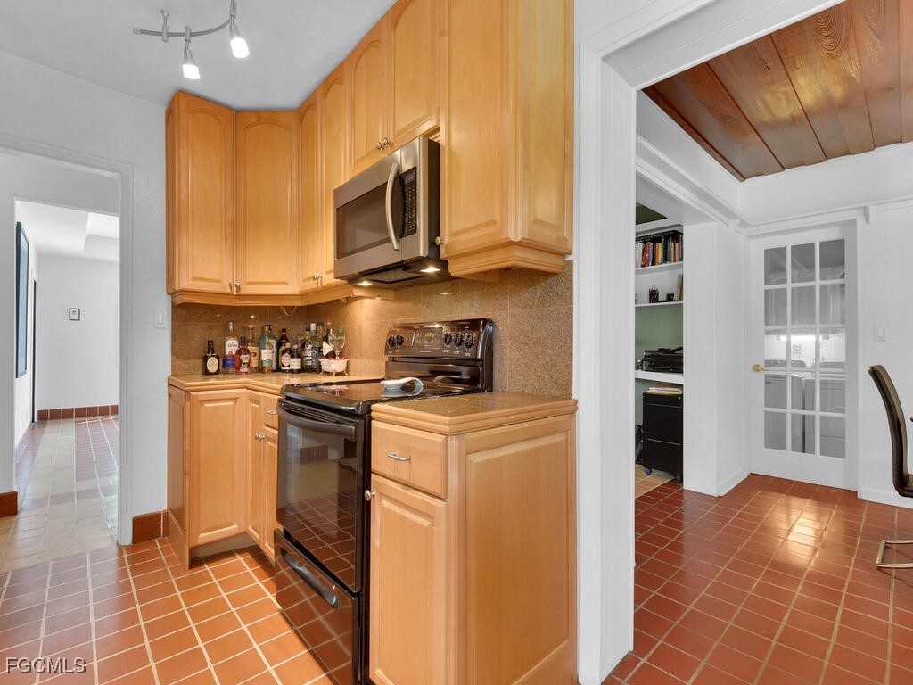 1803 Ardmore Road Fort Myers, FL 33901 - Photo 14 of 39 a kitchen with stainless steel appliances a stove a microwave and a refrigerator