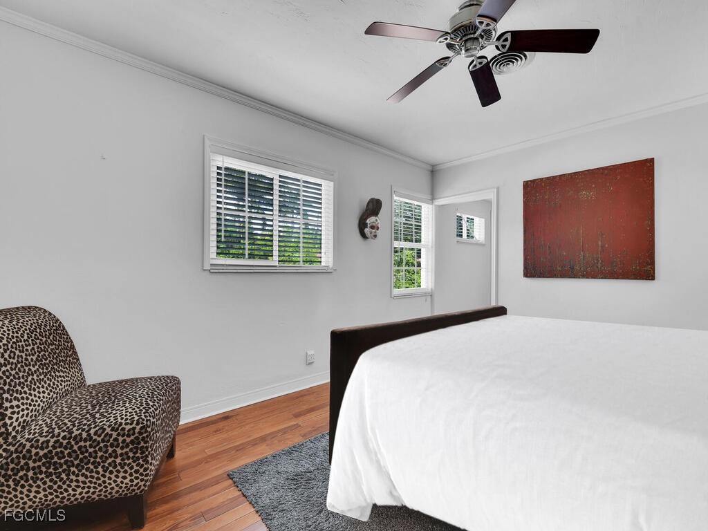 1803 Ardmore Road Fort Myers, FL 33901 - Photo 20 of 39 a bedroom with a bed and wooden floor