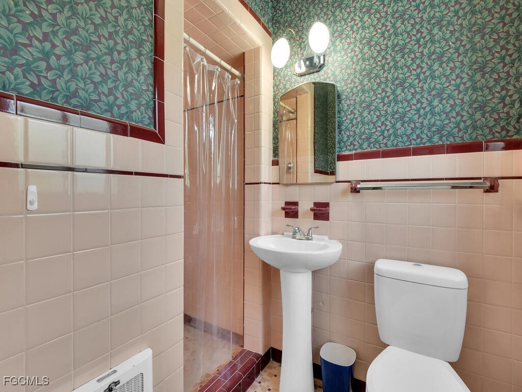 1803 Ardmore Road Fort Myers, FL 33901 - Photo 24 of 39 a bathroom with a toilet sink and mirror