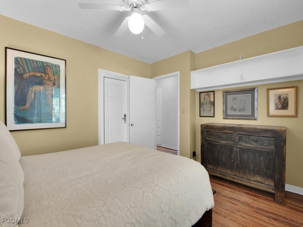 1803 Ardmore Road Fort Myers, FL 33901 - Photo 26 of 39 a bedroom with a bed and a chandelier