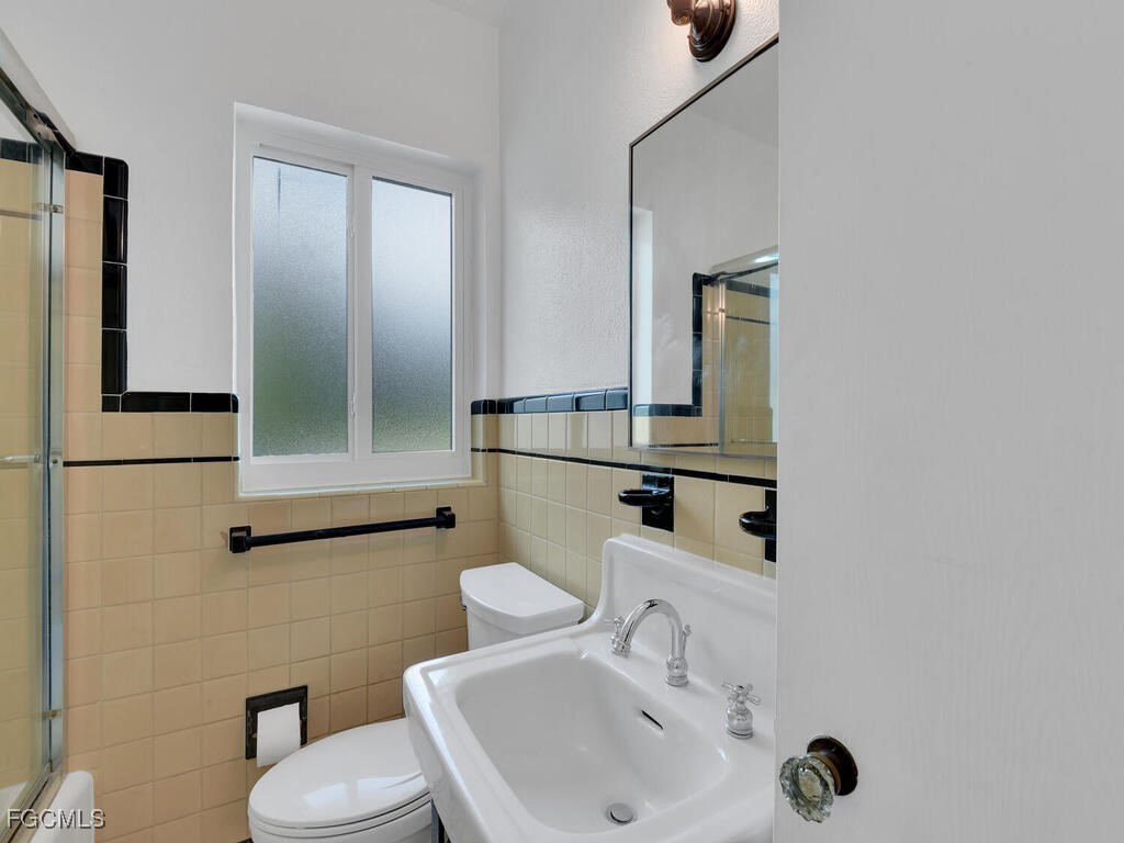1803 Ardmore Road Fort Myers, FL 33901 - Photo 27 of 39 a bathroom with a sink mirror and toilet