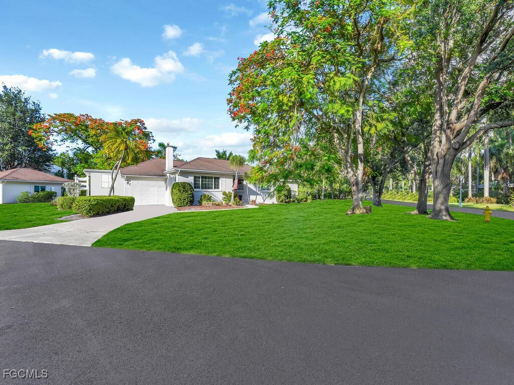 1803 Ardmore Road Fort Myers, FL 33901 - Photo 3 of 39 a view of a house with a big yard and large trees