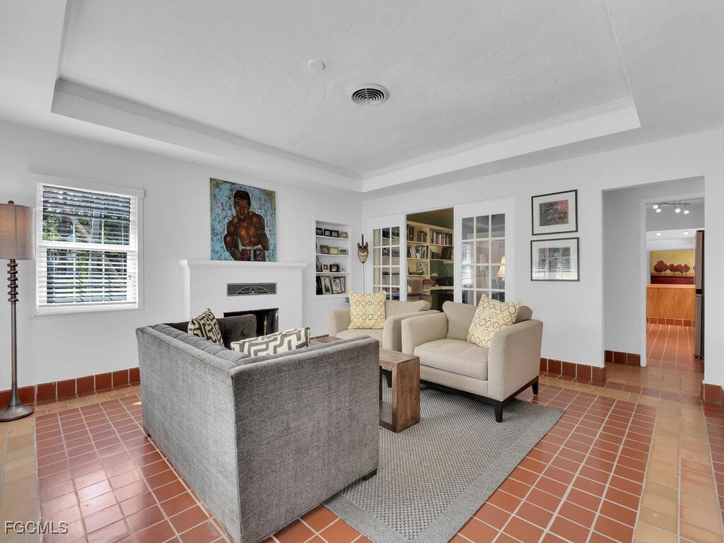 1803 Ardmore Road Fort Myers, FL 33901 - Photo 4 of 39 a living room with furniture and a fireplace