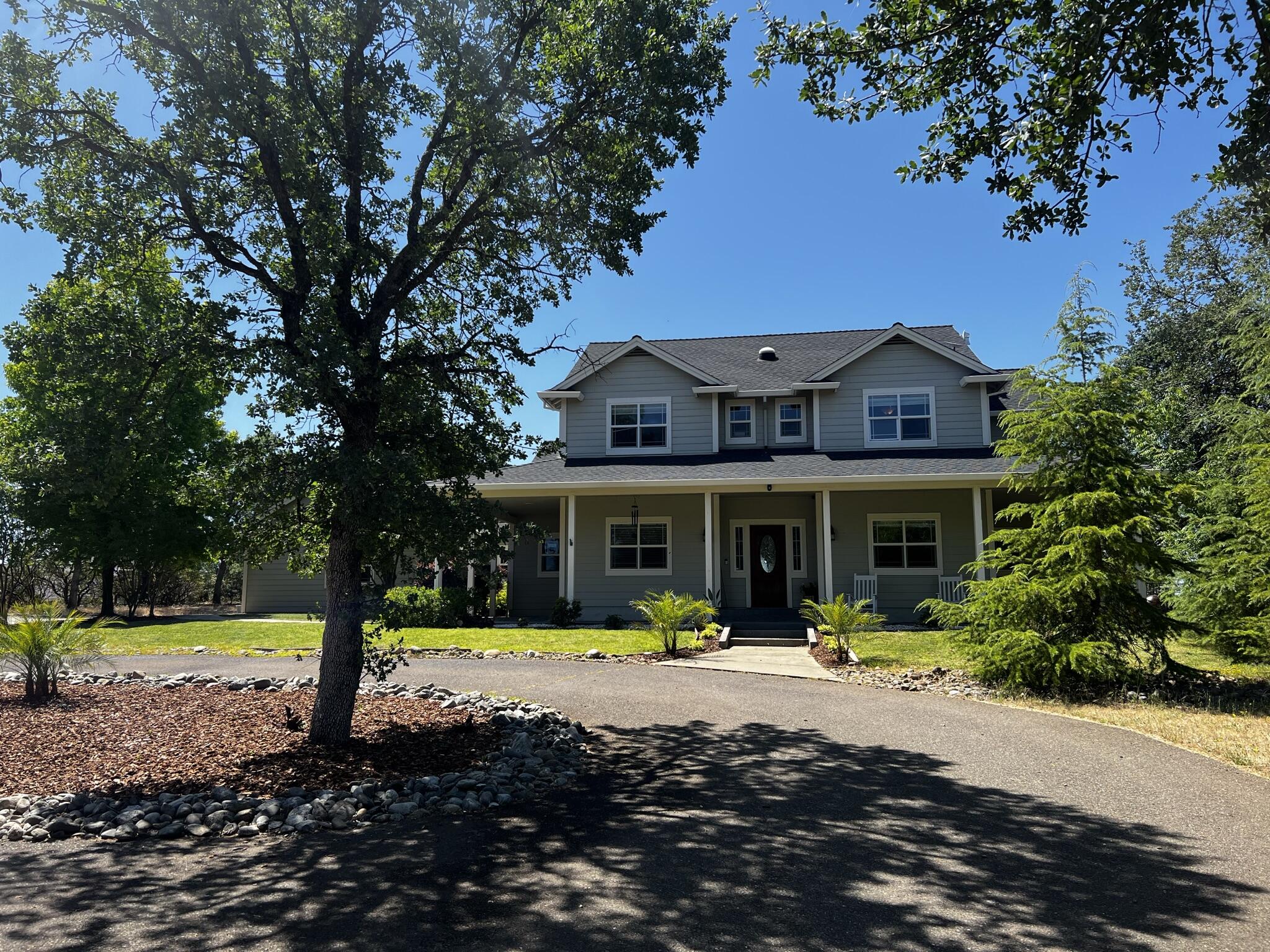 20901 Old 44 Drive Redding, CA 96003 - Photo 2 of 59 a front view of a house with swimming pool and porch with furniture