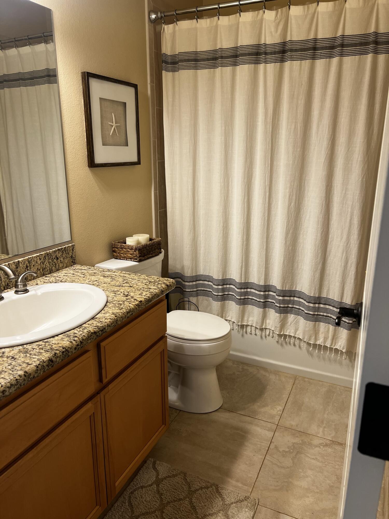 20901 Old 44 Drive Redding, CA 96003 - Photo 33 of 59 a bathroom with a granite countertop sink and a mirror