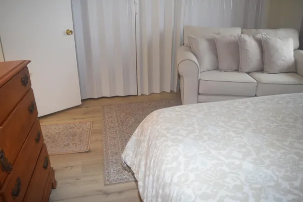 a bedroom with a bed and a chair