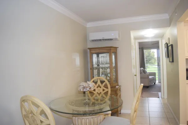 a room with a chandelier and a chair