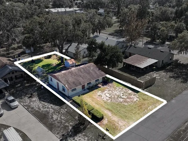 a view of a backyard with two chairs and a small yard