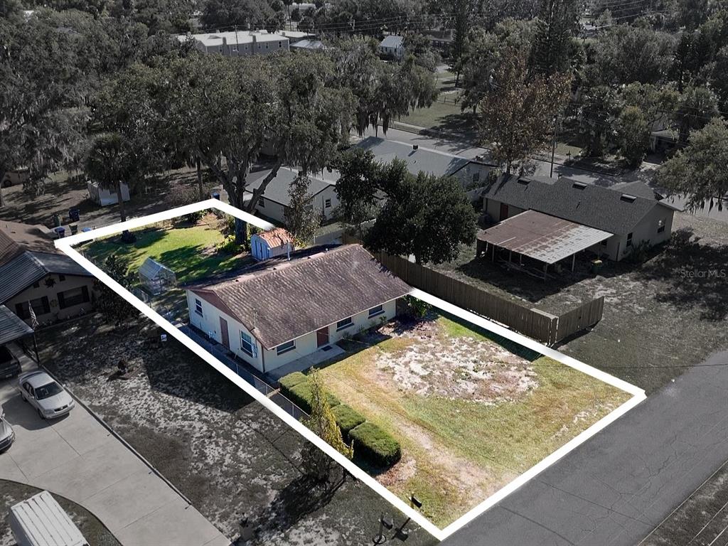 510 North Barrow Avenue Tavares, FL 32778 - Photo 29 of 33 a view of a backyard with two chairs and a small yard