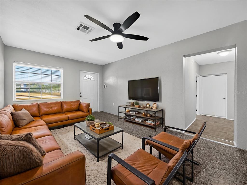 510 North Barrow Avenue Tavares, FL 32778 - Photo 4 of 33 a living room with furniture and a flat screen tv