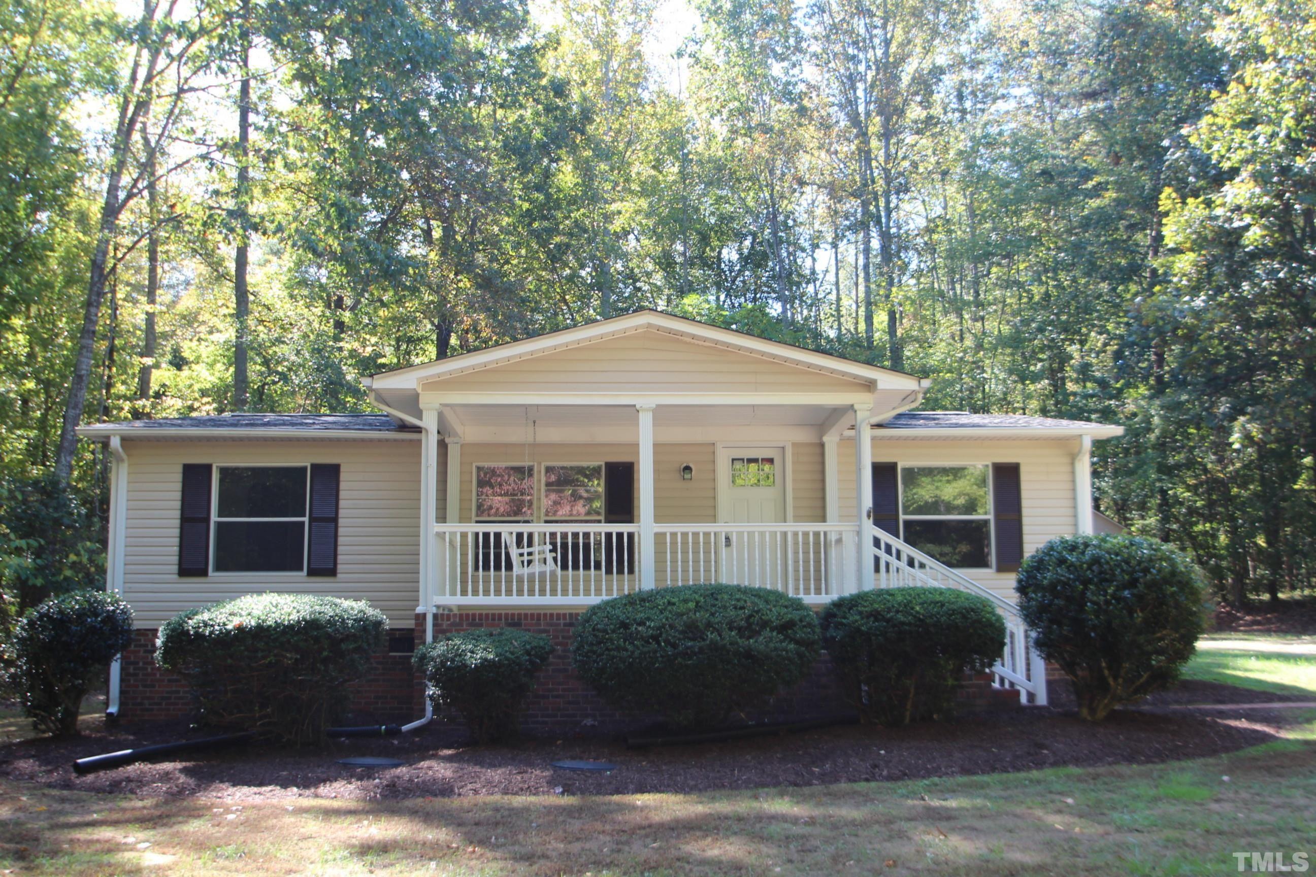 1075 Stoney Mountain Road Rougemont, NC 27572 - Photo 1 of 14 a front view of a house with a garden