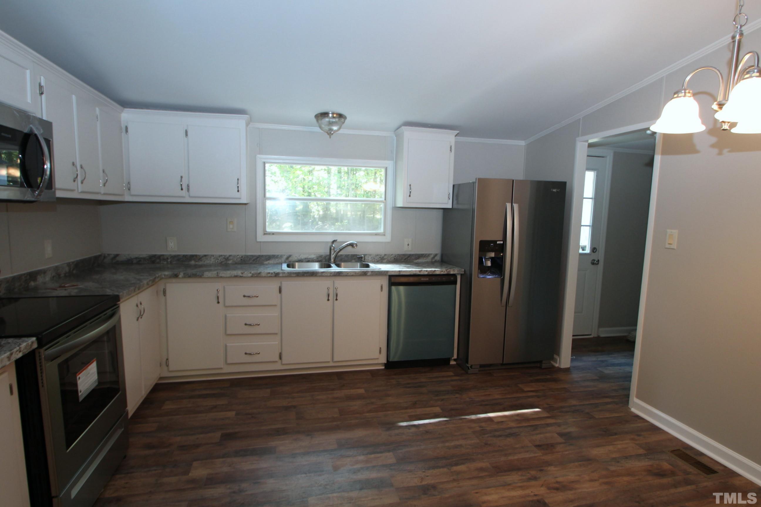 1075 Stoney Mountain Road Rougemont, NC 27572 - Photo 3 of 14 a kitchen with a refrigerator sink and cabinets