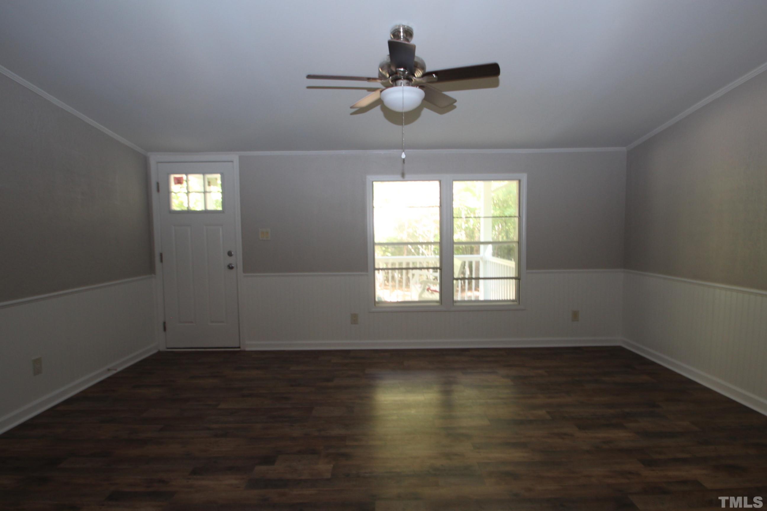 1075 Stoney Mountain Road Rougemont, NC 27572 - Photo 4 of 14 an empty room with wooden floor and windows