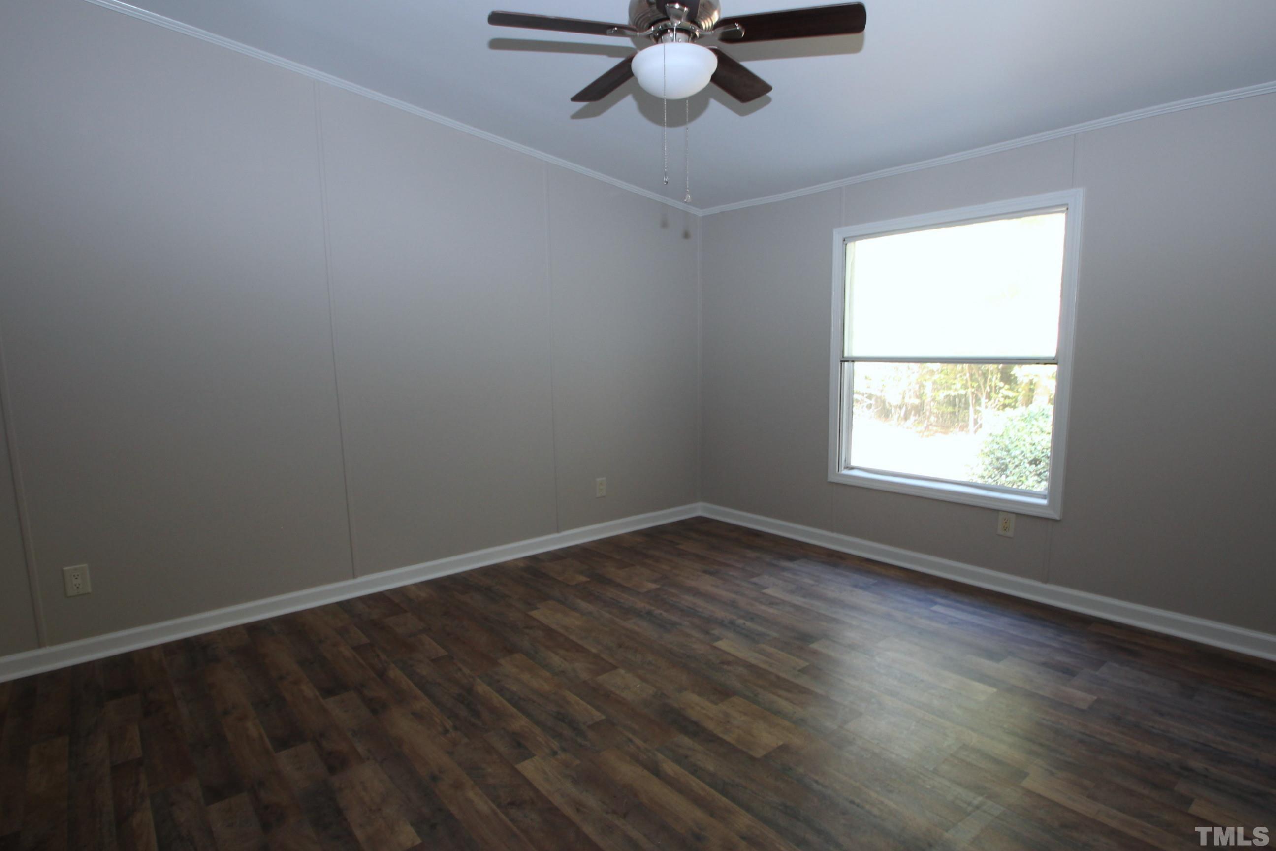 1075 Stoney Mountain Road Rougemont, NC 27572 - Photo 5 of 14 a view of an empty room with wooden floor and a window
