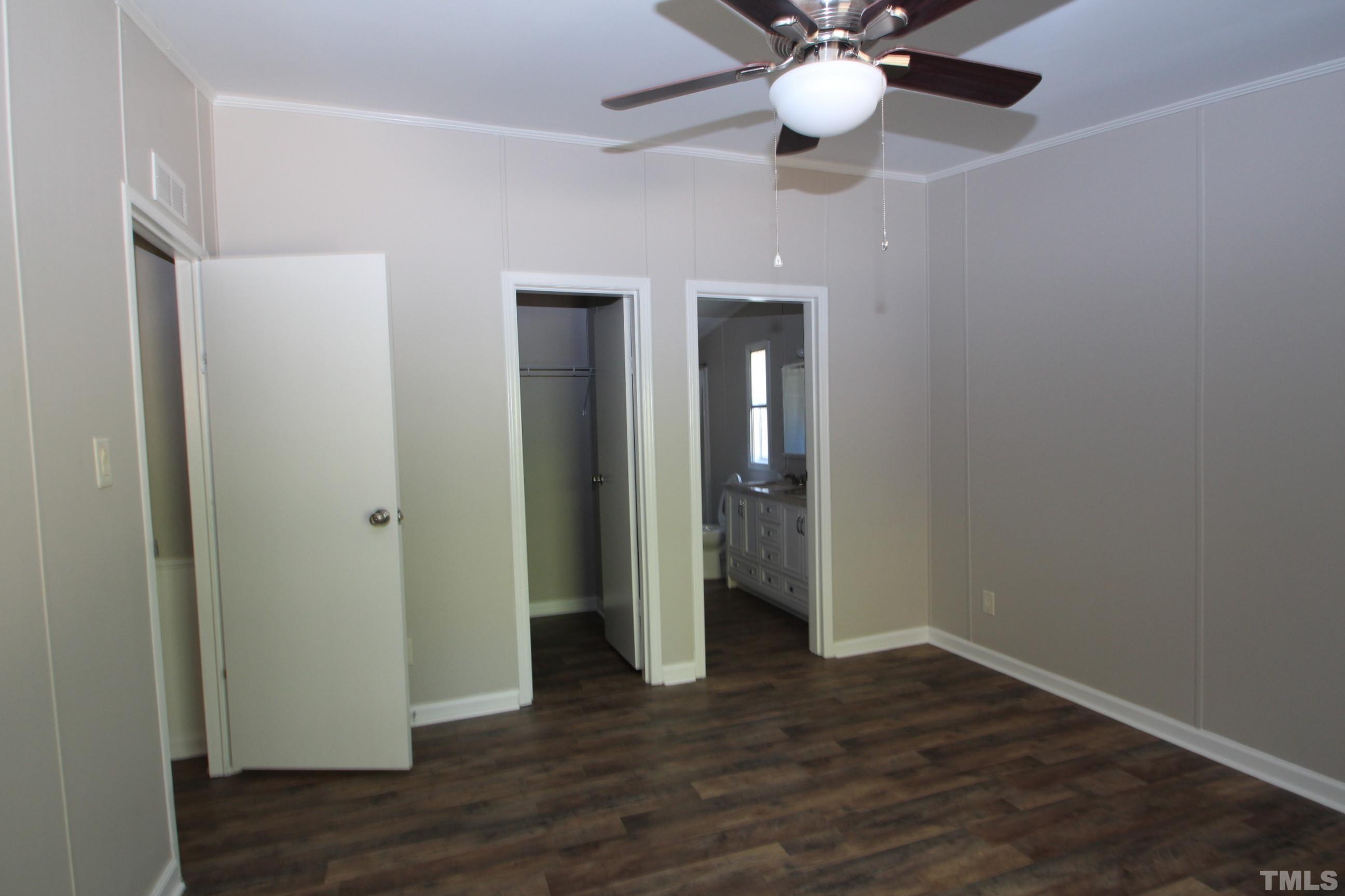 1075 Stoney Mountain Road Rougemont, NC 27572 - Photo 6 of 14 a view of an empty room with wooden floor and a ceiling fan