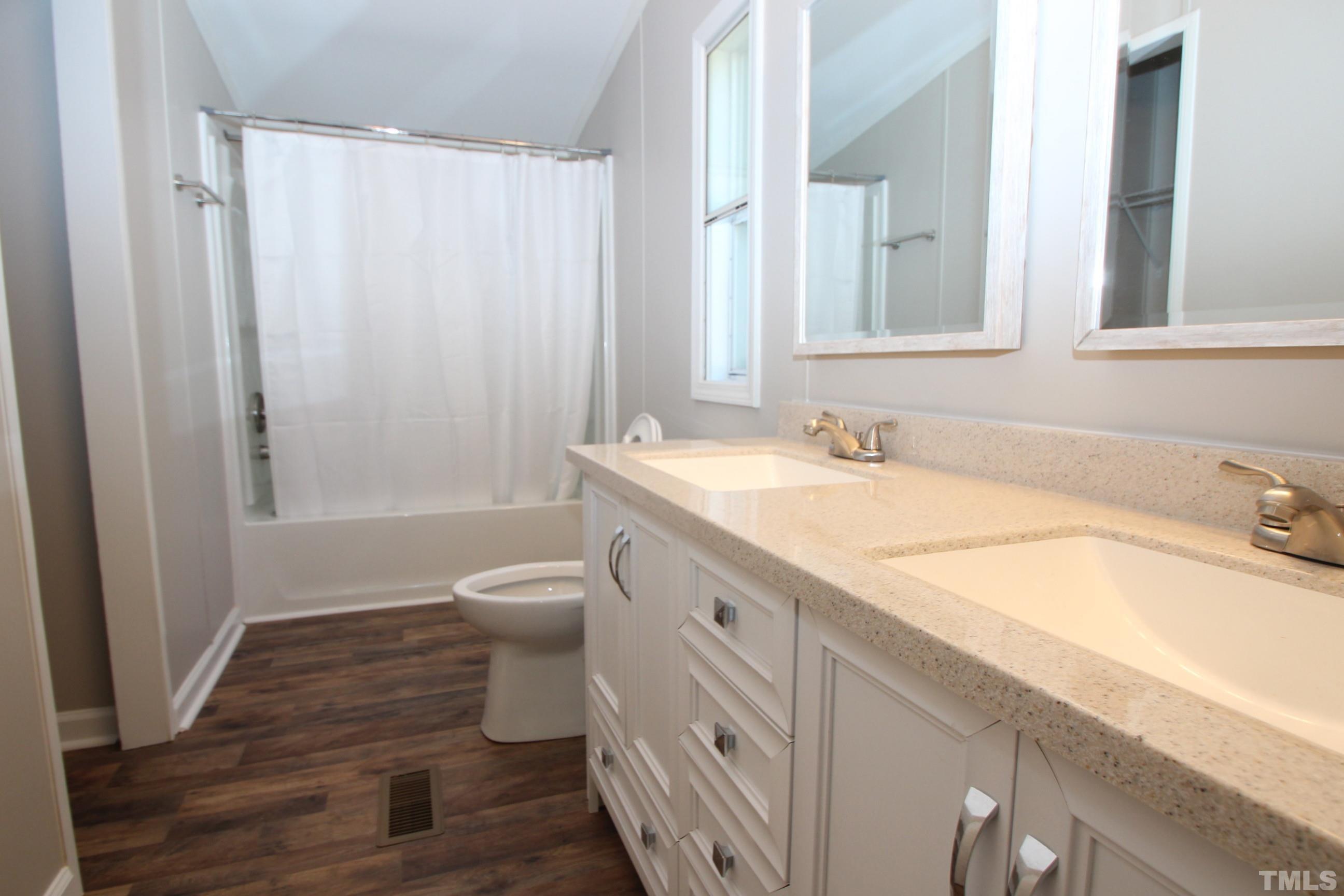1075 Stoney Mountain Road Rougemont, NC 27572 - Photo 7 of 14 a bathroom with a granite countertop sink toilet and shower