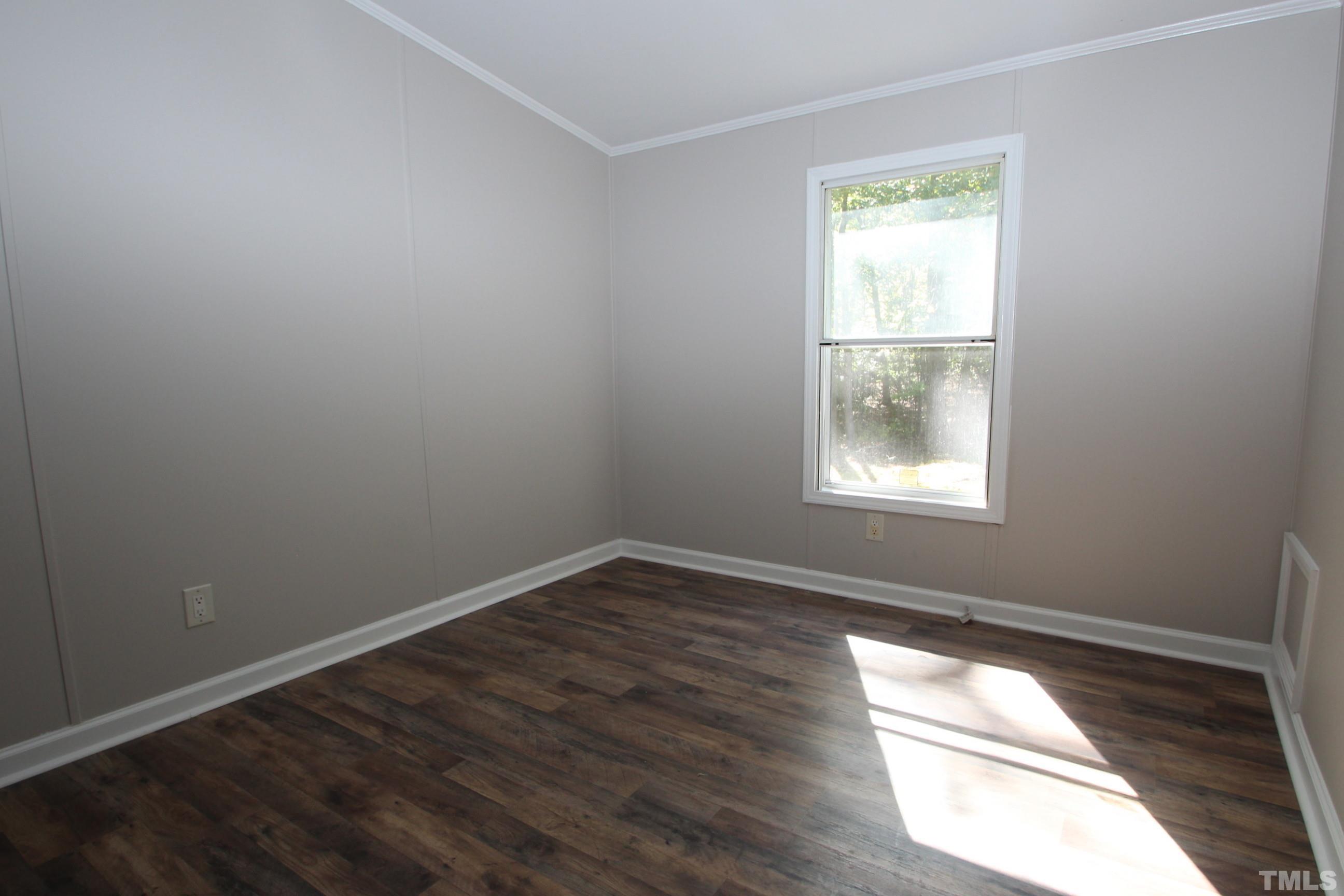 1075 Stoney Mountain Road Rougemont, NC 27572 - Photo 9 of 14 an empty room with wooden floor and windows