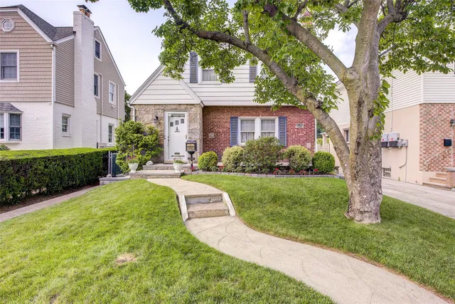 a front view of a house with garden