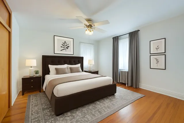 a bedroom with a large bed and a chandelier