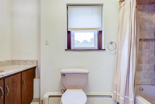 a white toilet sitting next to a bathroom sink