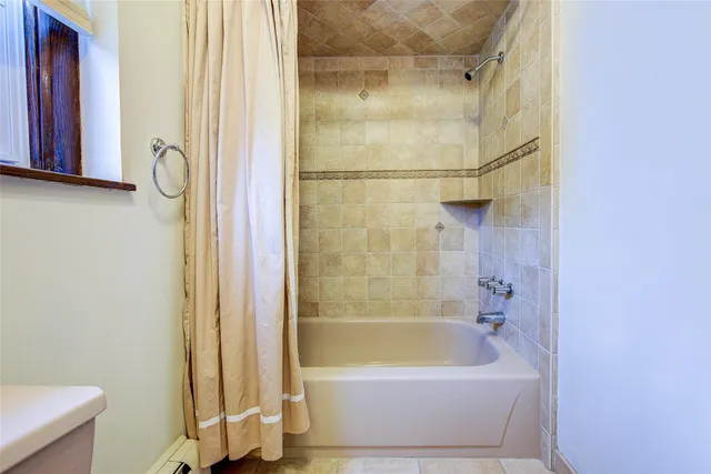 a bathroom with a bathtub and a shower