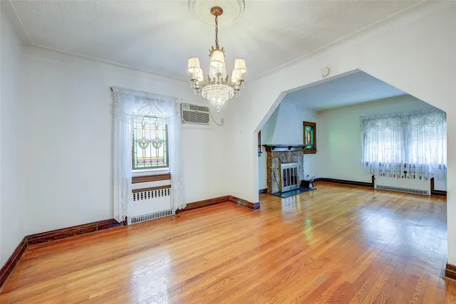 a view of a livingroom with a furniture wooden floor and windows