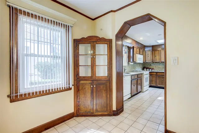 a view of a kitchen with a sink and dishwasher a refrigerator with wooden floor