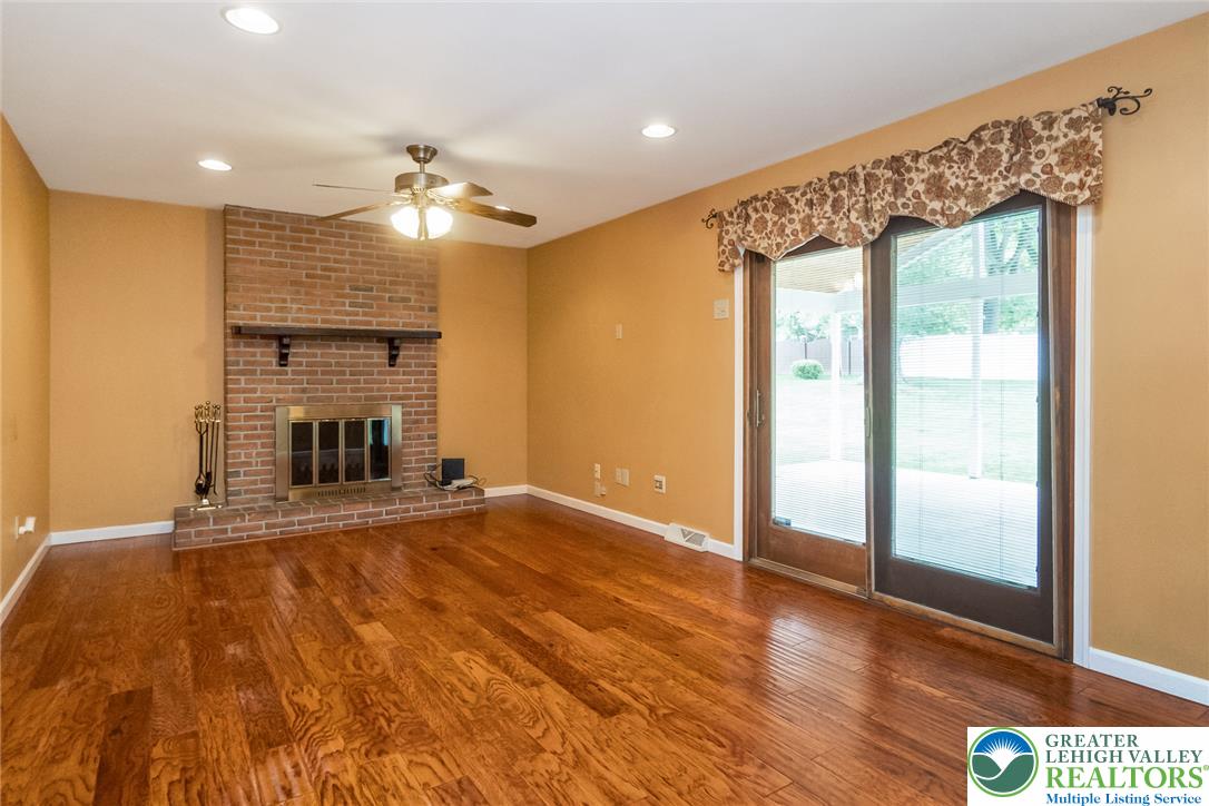 268 Apollo Drive Bethlehem, PA 18017 - Photo 18 of 56 A cozy Family Room iving space features a floor to ceiling brick fireplace, and direct access to outdoor living through sliding glass doors.