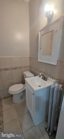a bathroom with a sink a toilet and mirror