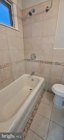 a bathroom with a bathtub and toilet