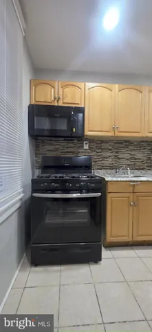 a stove top oven sitting inside of a kitchen