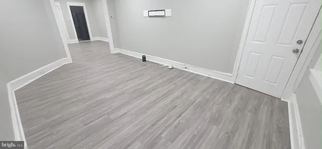 a view of a room with wooden floor