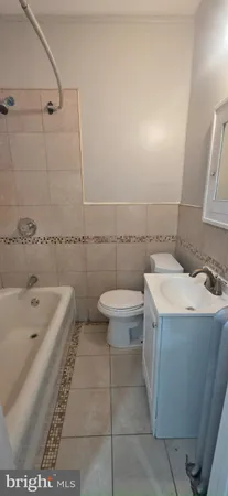 a bathroom with a sink a toilet and bathtub