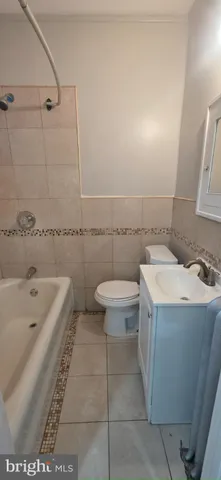 a bathroom with a sink a toilet and bathtub