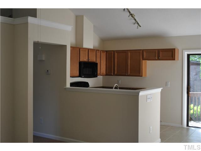 3322 Mill Run Raleigh, NC 27612 - Photo 5 of 16 a kitchen with stainless steel appliances a refrigerator and a stove top oven