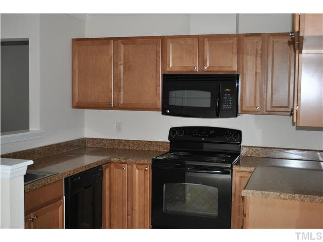 3322 Mill Run Raleigh, NC 27612 - Photo 6 of 16 a kitchen with granite countertop a stove and a microwave