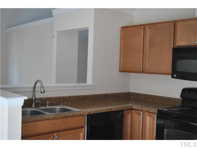 3322 Mill Run Raleigh, NC 27612 - Photo 7 of 16 a kitchen with a sink and cabinets