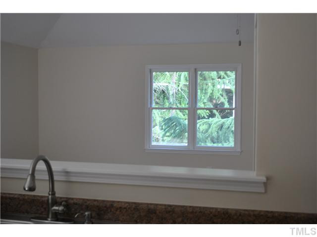 3322 Mill Run Raleigh, NC 27612 - Photo 9 of 16 a bathroom with a sink and a window