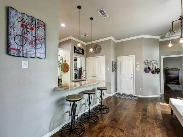 a view of a workspace with furniture and a kitchen