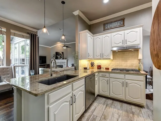 a kitchen with cabinets a sink and appliances