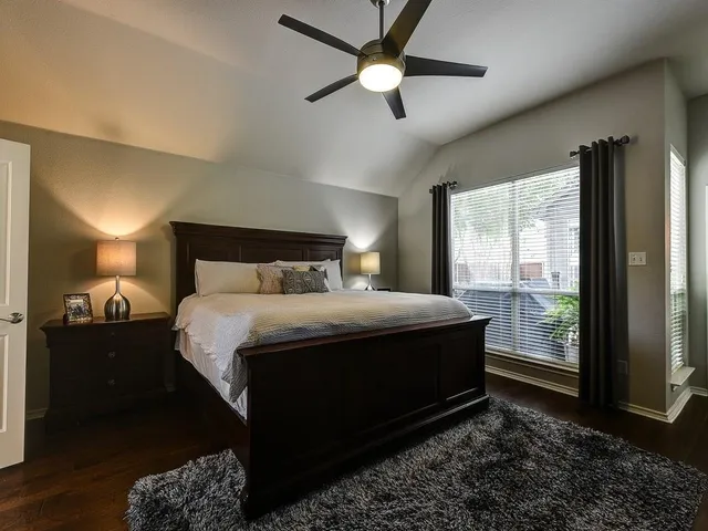 a bedroom with a large bed and a large window