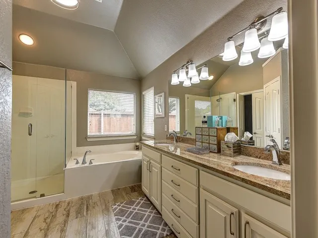 a large bathroom with a large tub sink and mirror