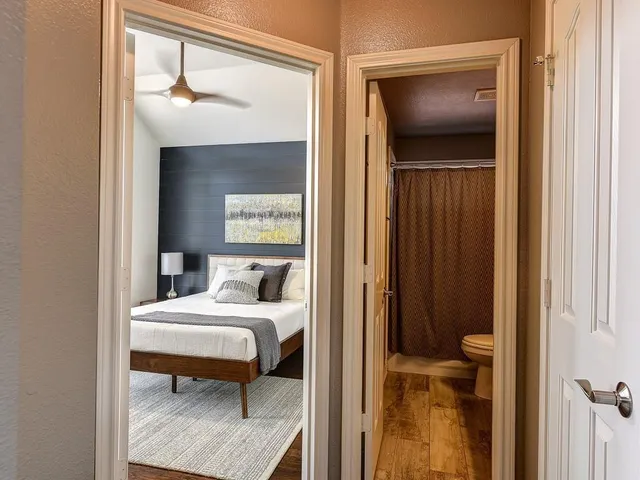 a bedroom with a bed and a mirror