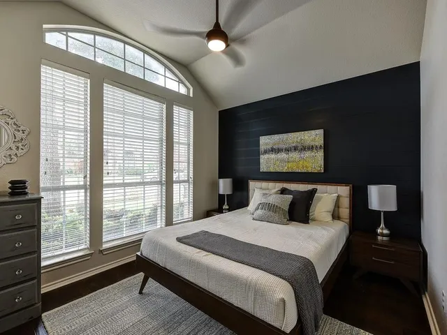 a bedroom with a large bed and a large window